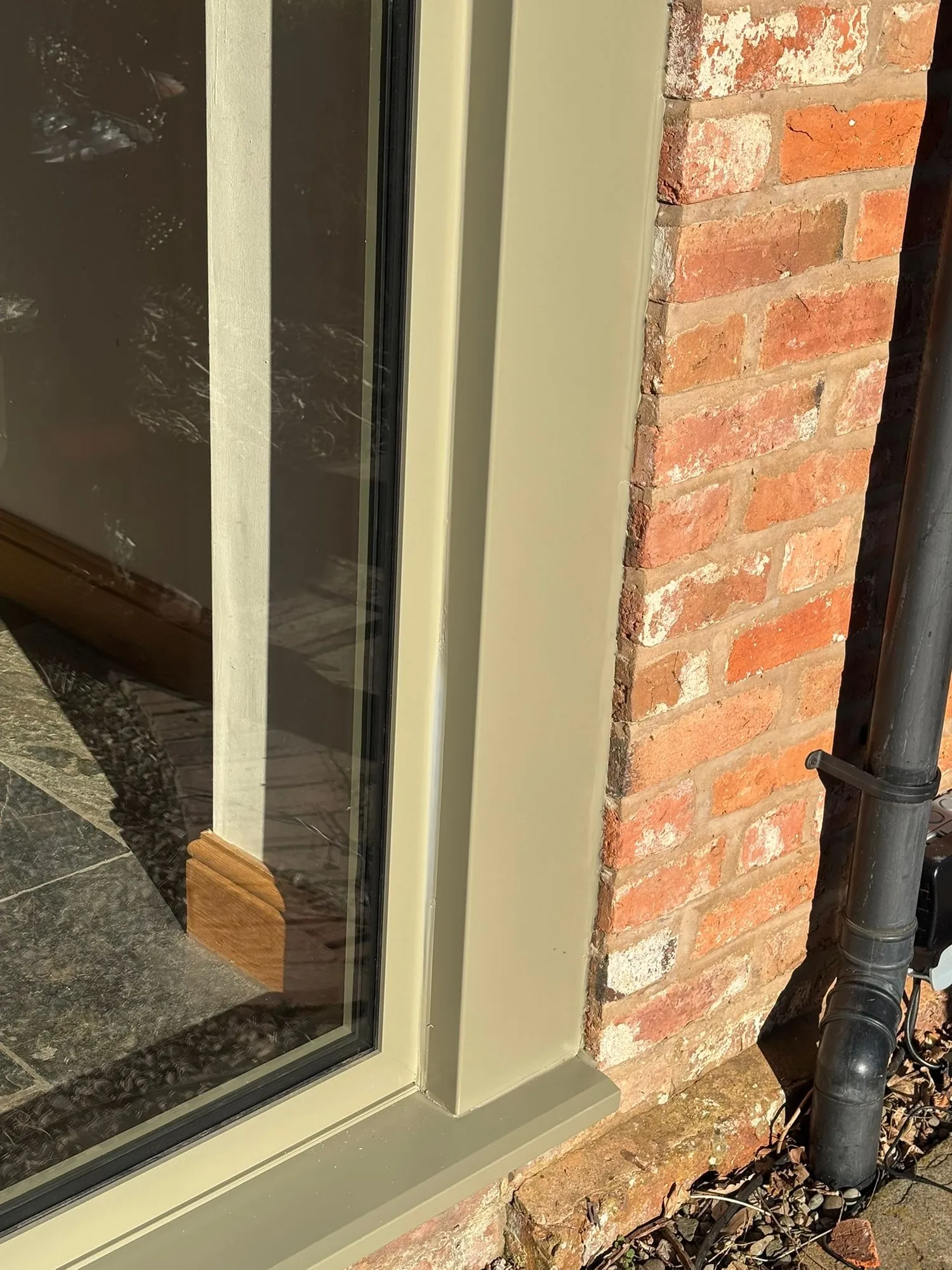 Detail of an aluminium frame sealed against brickwork in Redditch
