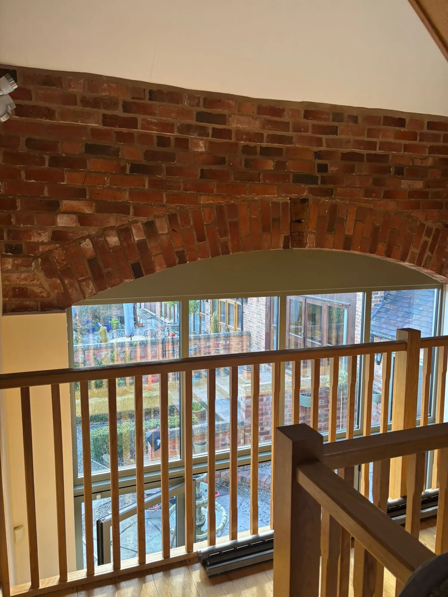 Aluminium glazing seen from inside beneath the brick arch in Redditch
