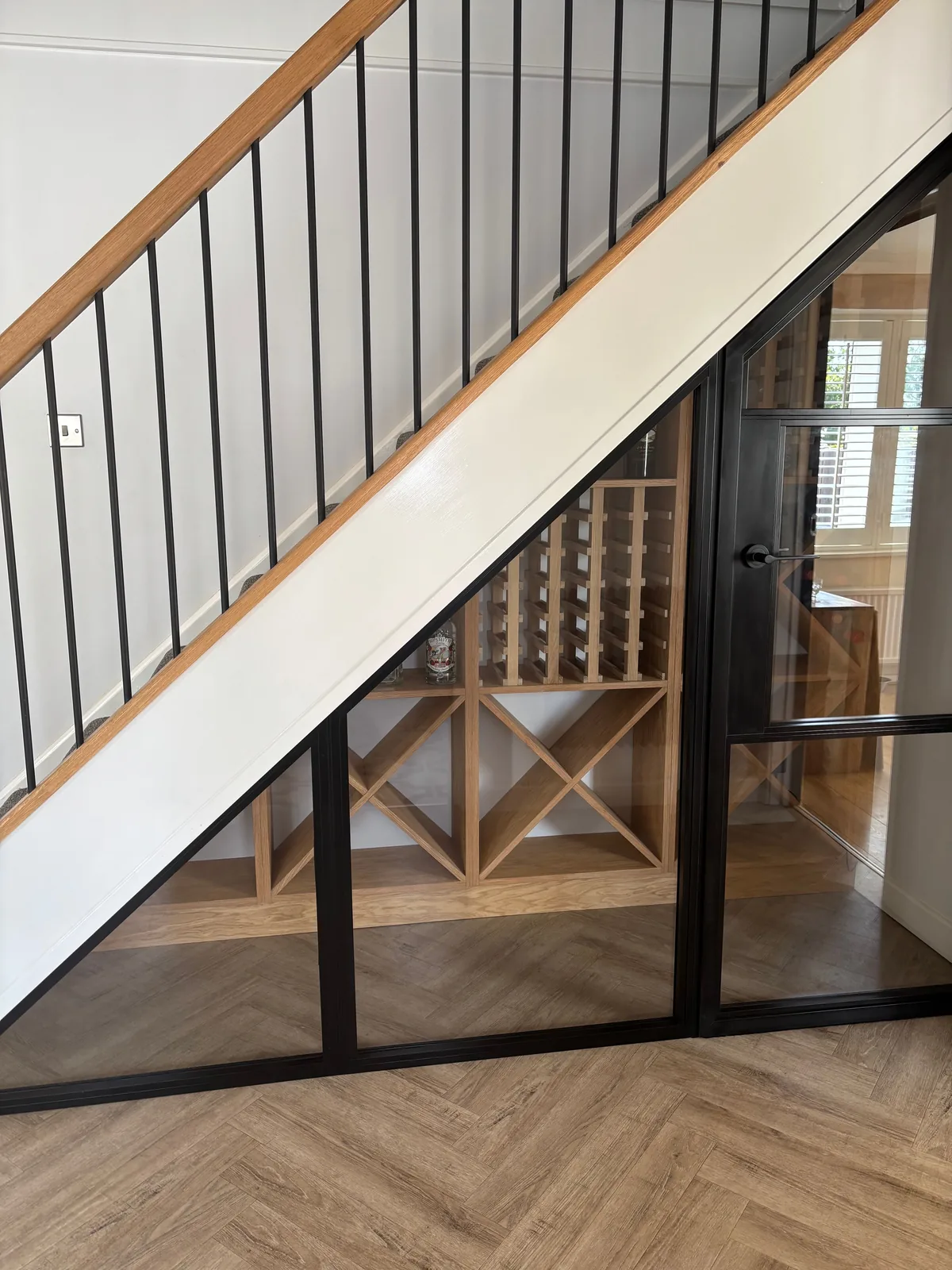 The finished under-stairs wine store in daylight, by Heritage Windows and Doors in the West Midlands