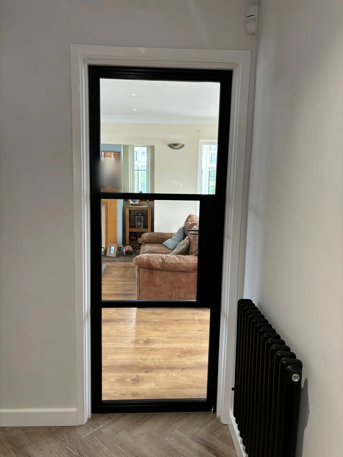 After: the same opening, clear-glazed through to the living room, by Heritage Windows and Doors in the West Midlands